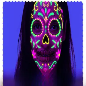 Close-up macro view of neon Day of the Dead fluorescent face tattoo sticker on a model