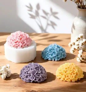 Marigold flower silicone mold with finished colorful candles displayed on wooden surface