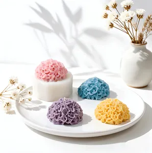 Detailed close-up view of marigold silicone mold with colorful handmade flower candles on plate