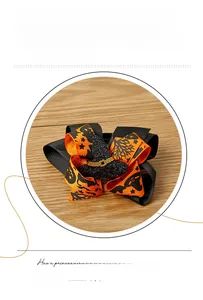 Detail view of Halloween bow hair clip with sparkling witch hat and pumpkin ribbon