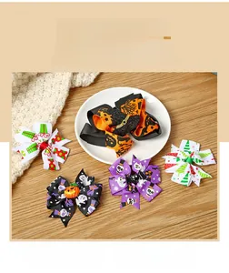 Detailed view of Halloween and Christmas bow hair clips on a warm wooden background.