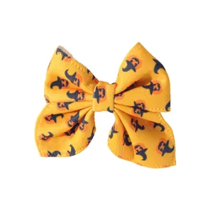 Yellow Halloween hair bow clip with festive pumpkin and witch hat pattern for kids