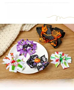 Detailed view of festive Halloween and Christmas themed bow hair clips on a plate