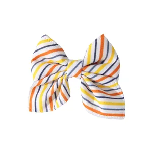 Halloween striped bow hair clip with orange and yellow diagonal patterns