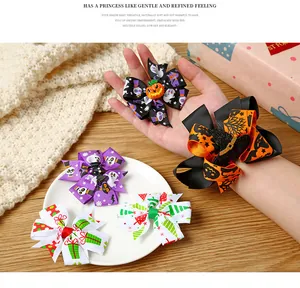 Detailed view of festive Halloween and Christmas themed hair bows for children