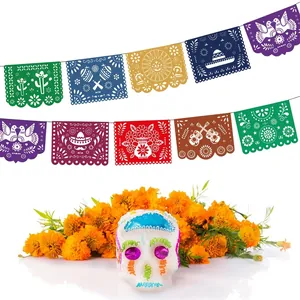 Colorful Mexican Papel Picado banner and sugar skull for Day of the Dead party decor