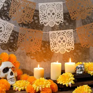 Detailed view of Mexican Day of the Dead banner with hollow skull design and festive candles