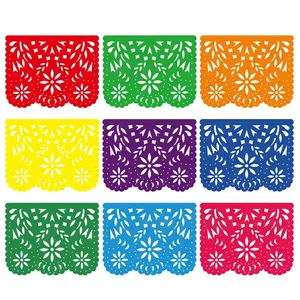 Colorful Mexican Papel Picado banners with intricate hollowed-out floral patterns.
