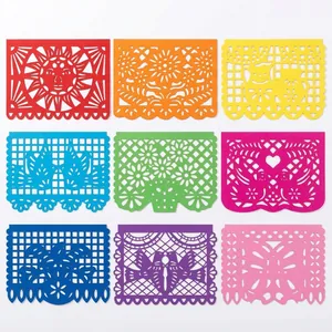 Detailed view of colorful hollow-out Mexican papel picado banners for party decor.