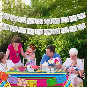 Traditional white laser-cut Mexican party banners used for festive family outdoor garden decorations