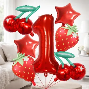 Close-up of strawberry and cherry foil balloon set for girl's first birthday party
