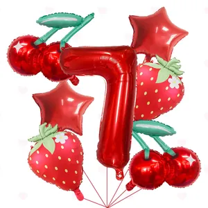 Macro view of strawberry and cherry shaped foil balloon set for birthday parties