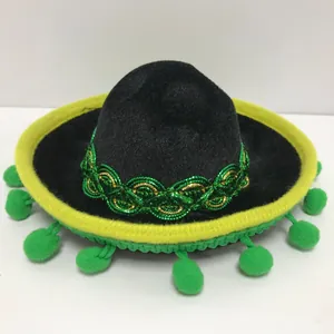 Detailed view of mini black Mexican sombrero hat with green pom-poms for parties