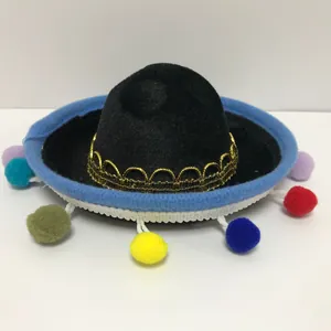 Detailed view of mini Mexican sombrero with colorful pom-poms and gold trim