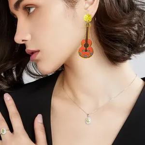 Detailed shot of a colorful Mexican guitar drop earring on a model for Cinco de Mayo
