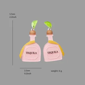 Detailed view of pink Tequila bottle earrings with size and weight measurements