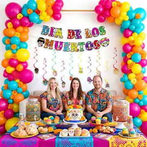 Detailed setup of Dia de los Muertos party decorations with colorful banner and balloons.