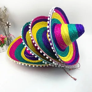 Sombreri messicani colorati impilati con pompon bianchi per feste ed eventi di ballo.
