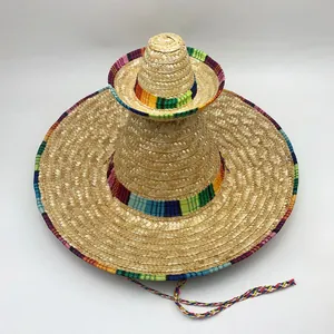 Close-up of stacked Mexican straw hats with vibrant rainbow-colored woven trim.