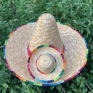 Detailed view of two Mexican straw sombreros with vibrant rainbow-colored woven edges