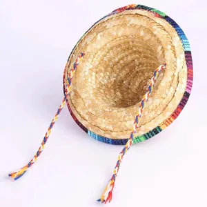 Detailed view of traditional Mexican straw sombrero with colorful woven trim and cords.
