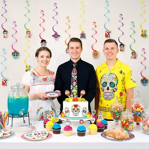 Day of the Dead party scene with vibrant skull cupcake toppers and hanging swirls.
