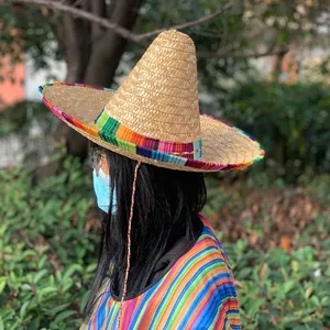 Detail of Mexican straw hat with vibrant colorful striped trim and pointed crown