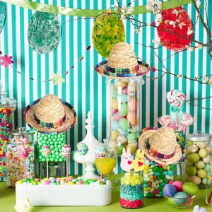 Miniature Mexican straw sombrero hats with colorful woven bands for fiesta party decor