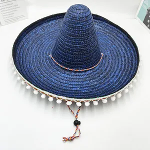Detalle de un sombrero charro mexicano azul tejido con flecos de pompones blancos.