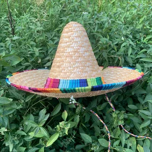 Authentic Mexican straw sombrero hat with pointed crown and colorful fabric trim.