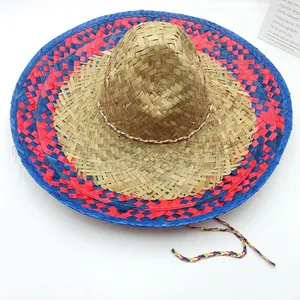 Detailed close-up view of vibrant red and blue woven patterns on a natural Mexican straw hat.