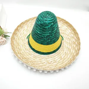 Top view of a woven Mexican sombrero hat with green yellow stripes and pom-pom trim