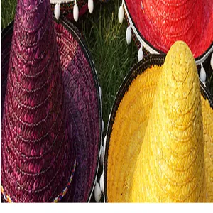 Close-up detail of colorful woven Mexican sombreros with white pom-pom trim
