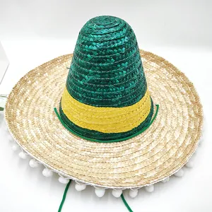 Detailed view of Mexican wheat straw sombrero with green and yellow stripes and white pom-poms.