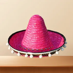 Vibrant pink Mexican straw sombrero with white pom-pom trim for kids carnival costumes.