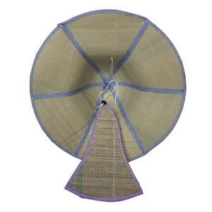 Detail view of the interior of a woven Mexican straw hat with a blue striped trim.