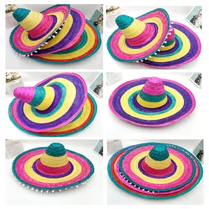 Colorful Mexican straw sombreros with white pom-poms for festive party decoration