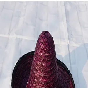 Close-up of the woven peak on a purple Mexican straw hat accessory for Halloween parties