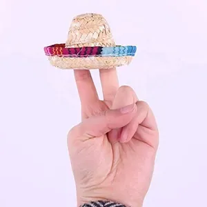 Dettaglio mini cappello di paglia messicano tenuto tra le dita per mostrare le dimensioni.