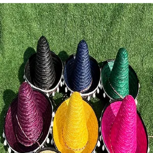 Set of six vibrant Mexican sombreros with white pompom trim displayed on green grass