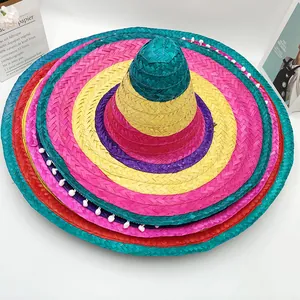 Detail view of colorful Mexican sombrero with white pom-poms and woven texture