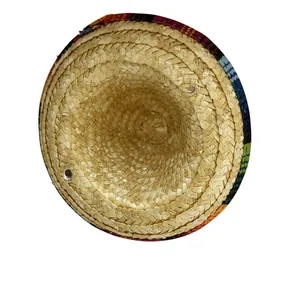 Detail of Mexican carnival straw hat showing intricate weave and colorful brim patterns.