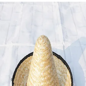 Detail showing the intricate natural straw weave of a Mexican carnival party hat crown