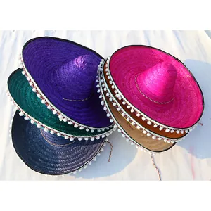 Colorful Mexican straw sombreros with white pom-pom trim in a stacked detail view
