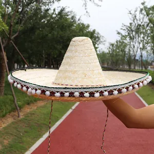 Traditional Mexican straw sombrero with colorful decorative pom-poms edge