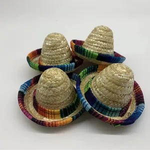 Set of four mini handwoven Mexican straw hats for pets featuring colorful festive fabric edges