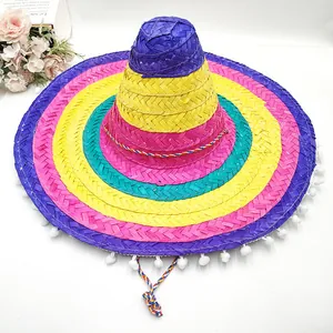 Detail view of colorful Mexican sombrero with white pom-poms and woven texture