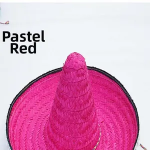 Detailed view of a vibrant magenta woven Mexican straw hat for carnival parties
