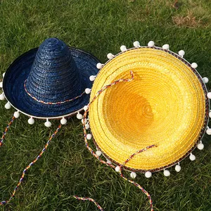 Blue and yellow Mexican straw hats with white pom poms for Halloween party props