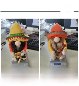Weight detail of Mexican carnival gnomes showing 63.6g and 65g on digital scales
